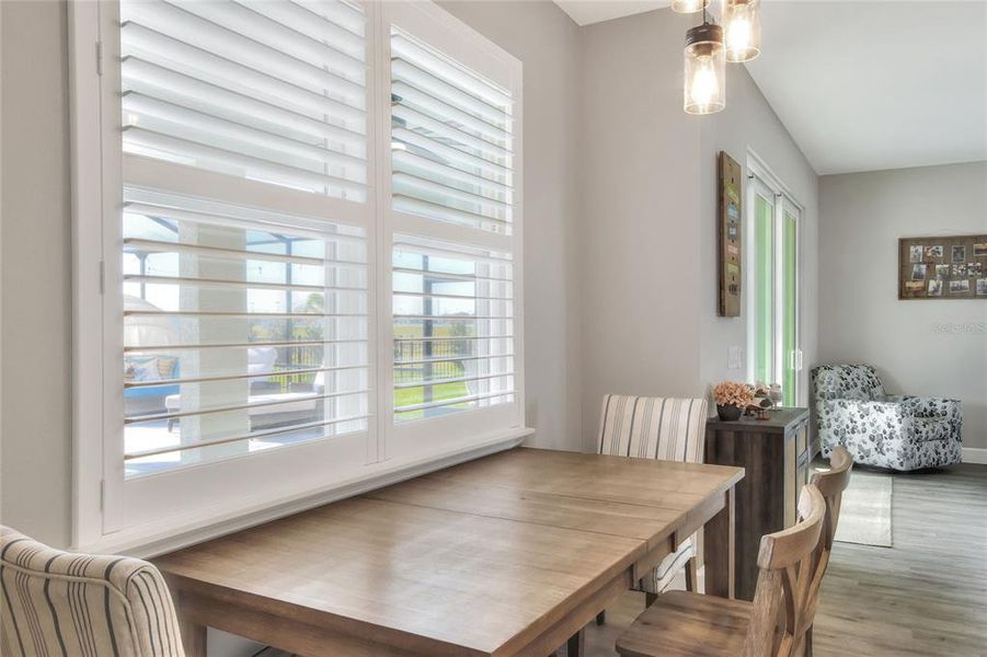 Casual dining area in Kitchen overlooks Lanai and Pool.