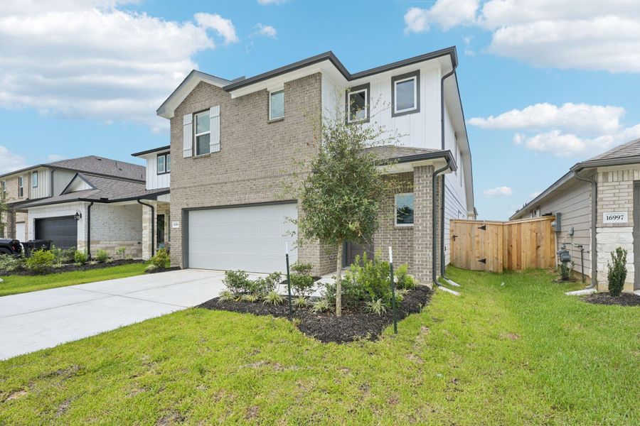 Front exterior of a new home in Mavera, Conroe, TX, highlighting curb appeal (Image 21). Front exterior of a new home in Mavera, Conroe, TX, highlighting curb appeal (Image 21).