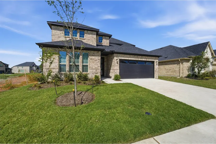 Front exterior of a new home in Green Meadows, Celina, TX, highlighting curb appeal (Image 2). Front exterior of a new home in Green Meadows, Celina, TX, highlighting curb appeal (Image 2).