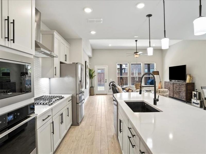 That clean, modern kitchen vibe that still feels warm and totally livable. Under those pendant lights is where your favorite recipes (and maybe some takeout) will shine. That clean, modern kitchen vibe that still feels warm and totally livable. Under those pendant lights is where your favorite recipes (and maybe some takeout) will shine.