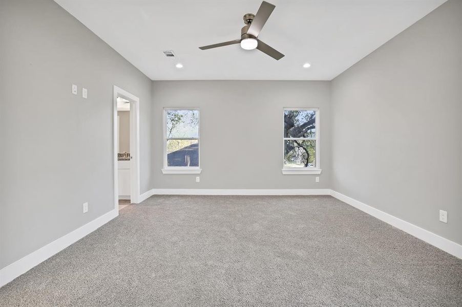 Unfurnished room with ceiling fan and carpet floors