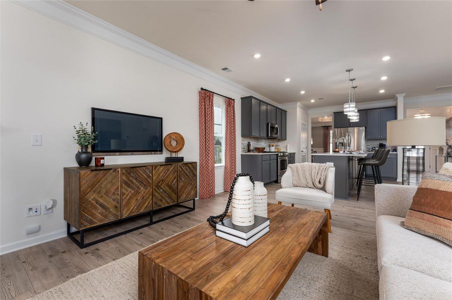 The Palmer- Family Room into the Kitchen. The sample image is a staged model, to be used for illustrative purposes only. Upgrades, options, and colors will vary. The Palmer- Family Room into the Kitchen. The sample image is a staged model, to be used for illustrative purposes only. Upgrades, options, and colors will vary.