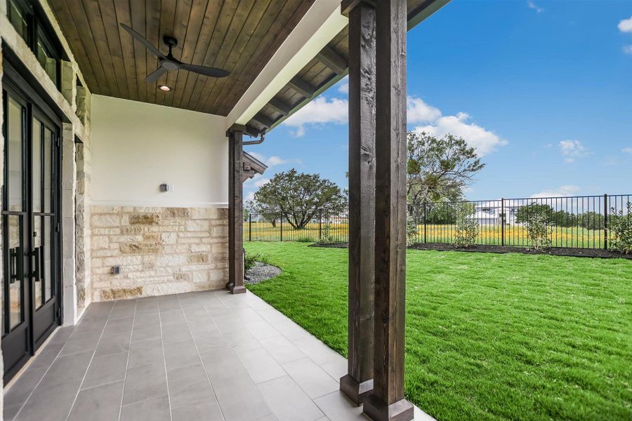 Covered patio with large format tile flooring and a wood-plank ceiling