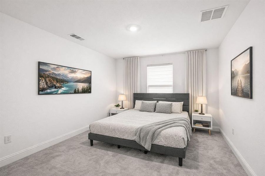 Bedroom with baseboards and light carpet