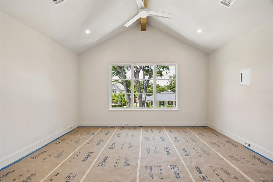 One of the secondary bedrooms upstairs. All bedrooms have specialty ceilings - cathedral with white oak beams or coffered.