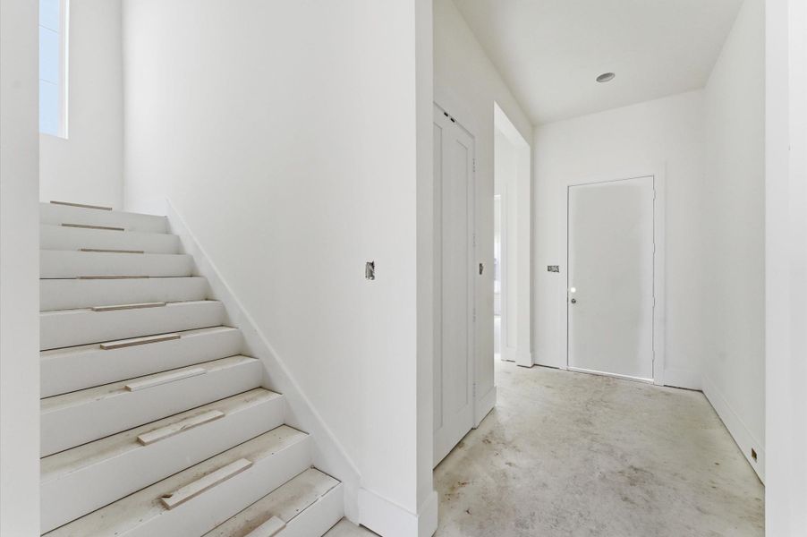 View of the front door and the adjacent future elevator or storage closet.