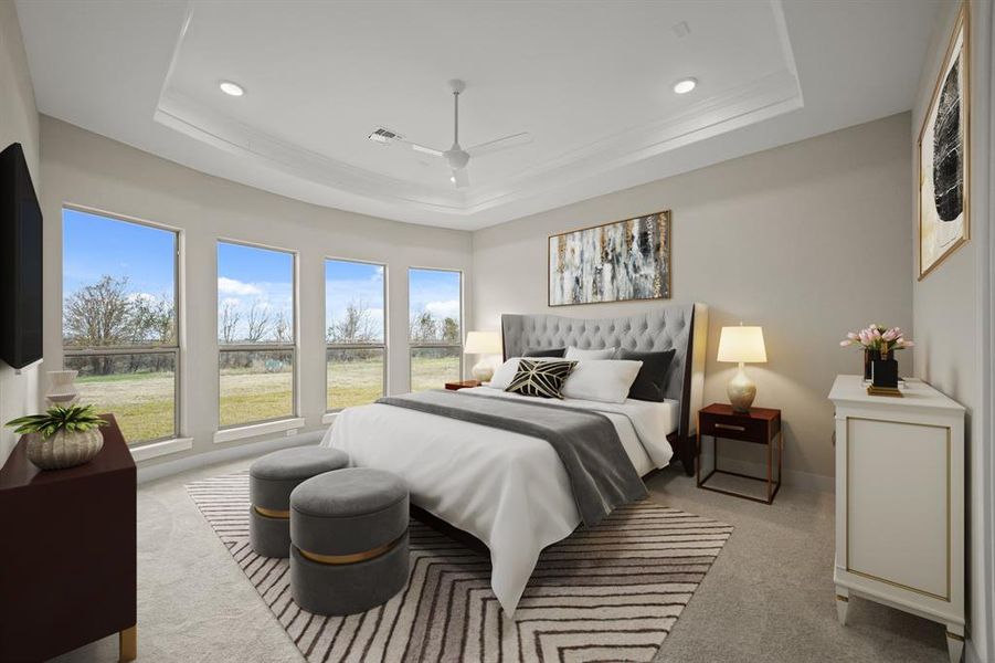 Virtually Staged: Unwind after a long day in this spacious Primary Bedroom! Featuring lots of natural light, carpet floors, a tray ceiling with a ceiling fan, and recessed lighting.