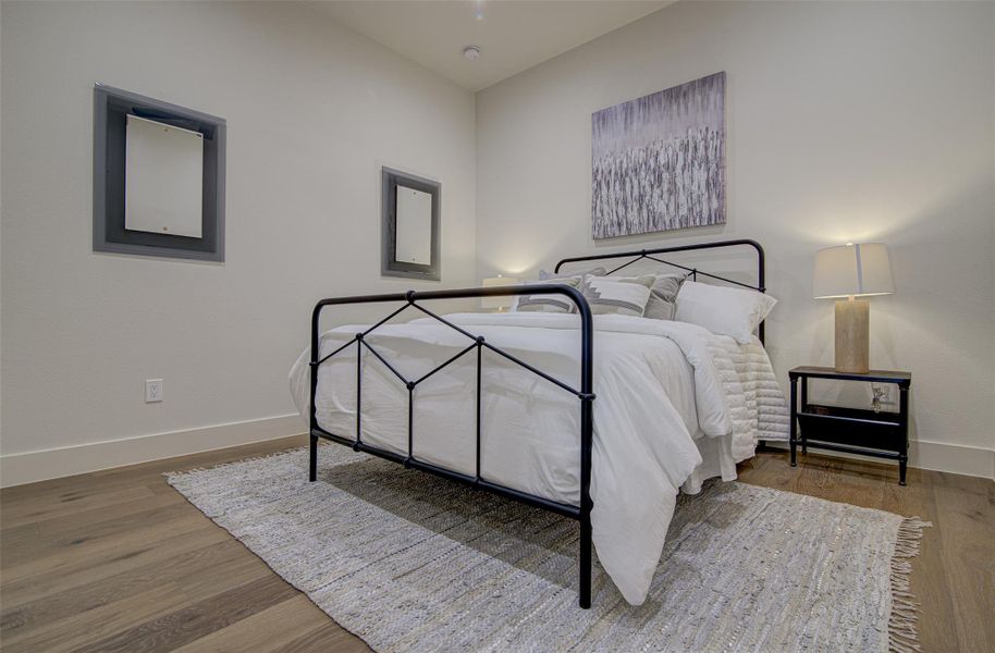 Bedroom with baseboards and wood finished floors Bedroom with baseboards and wood finished floors