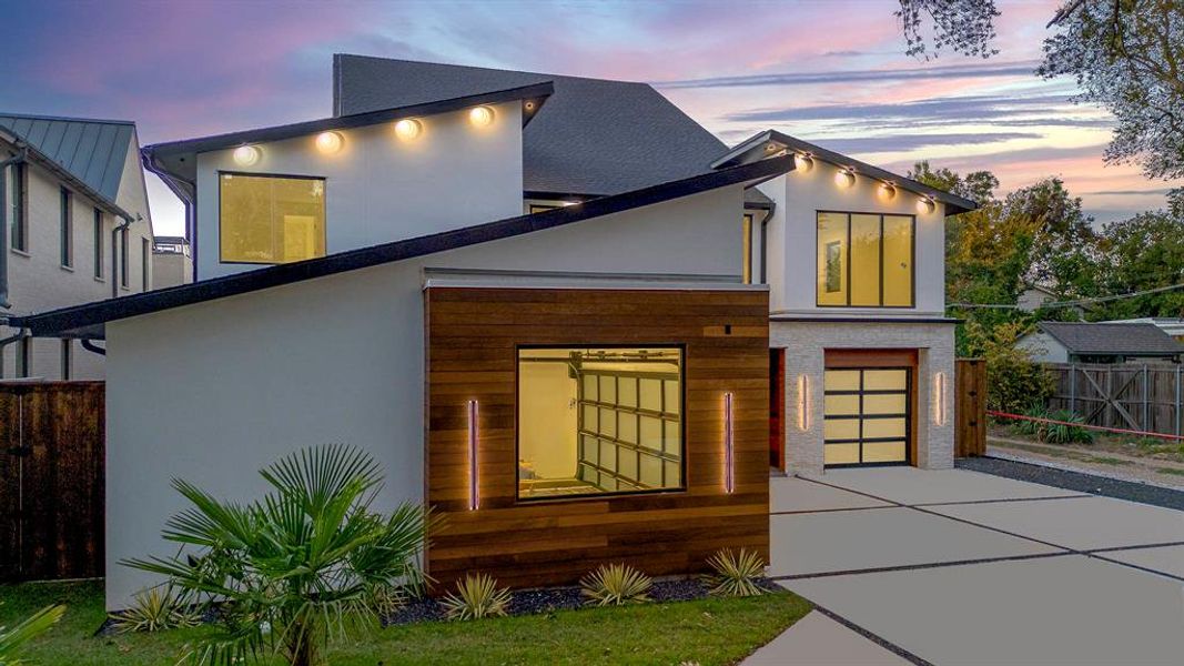 View of front of house featuring stucco siding, driveway, and a garage View of front of house featuring stucco siding, driveway, and a garage