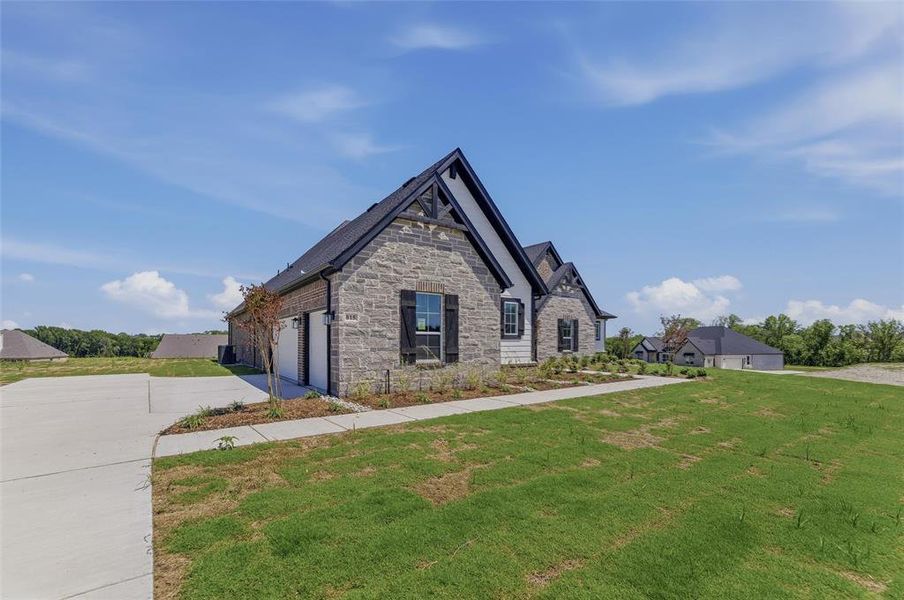 Stone and siding exterior with dark gables