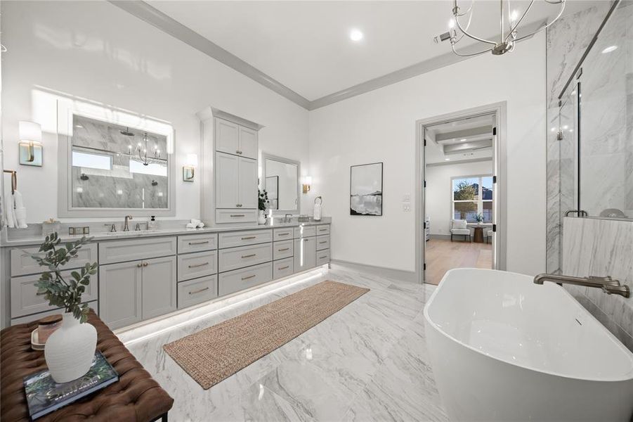 Full bathroom featuring double vanity, a marble finish shower, hanging lights, light marble finish flooring, and a freestanding tub Full bathroom featuring double vanity, a marble finish shower, hanging lights, light marble finish flooring, and a freestanding tub