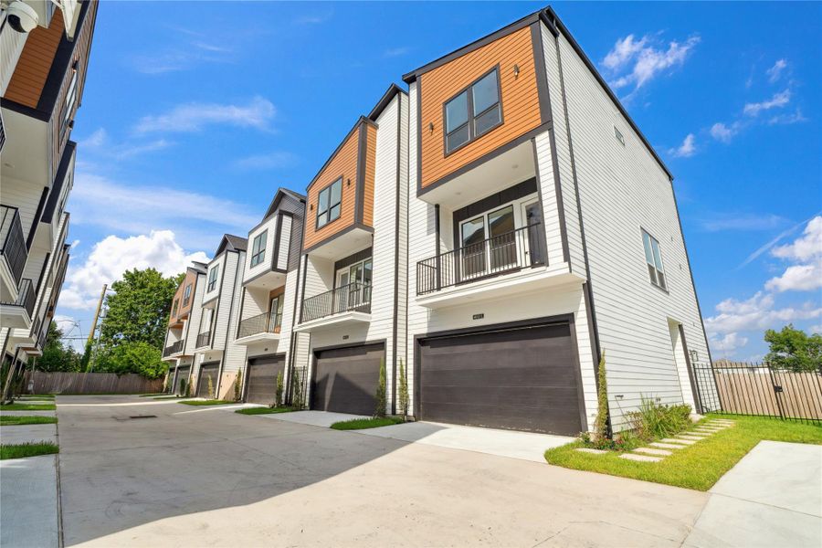 A striking streetscape presence, this modern elevation commands attention with a bold blend of warm-toned paneling and crisp vertical siding.