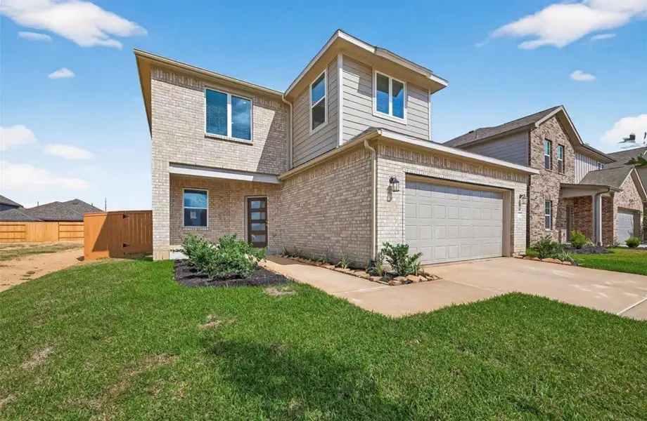 Front exterior of a new home in Sunterra, Katy, TX, highlighting curb appeal (Image 1). Front exterior of a new home in Sunterra, Katy, TX, highlighting curb appeal (Image 1).