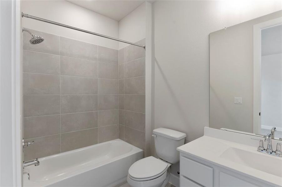 Full bath featuring vanity and washtub / shower combination