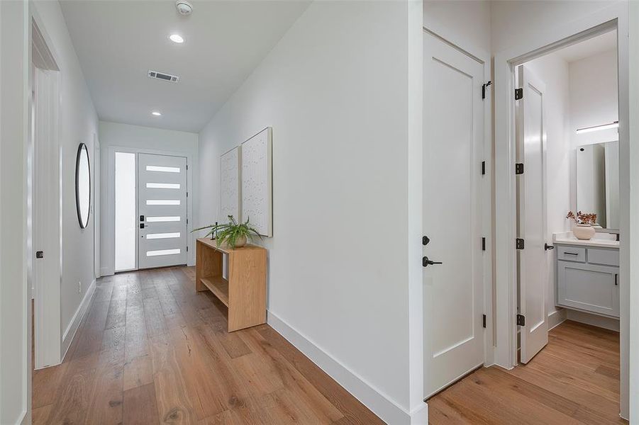 Corridor with light hardwood / wood-style floors