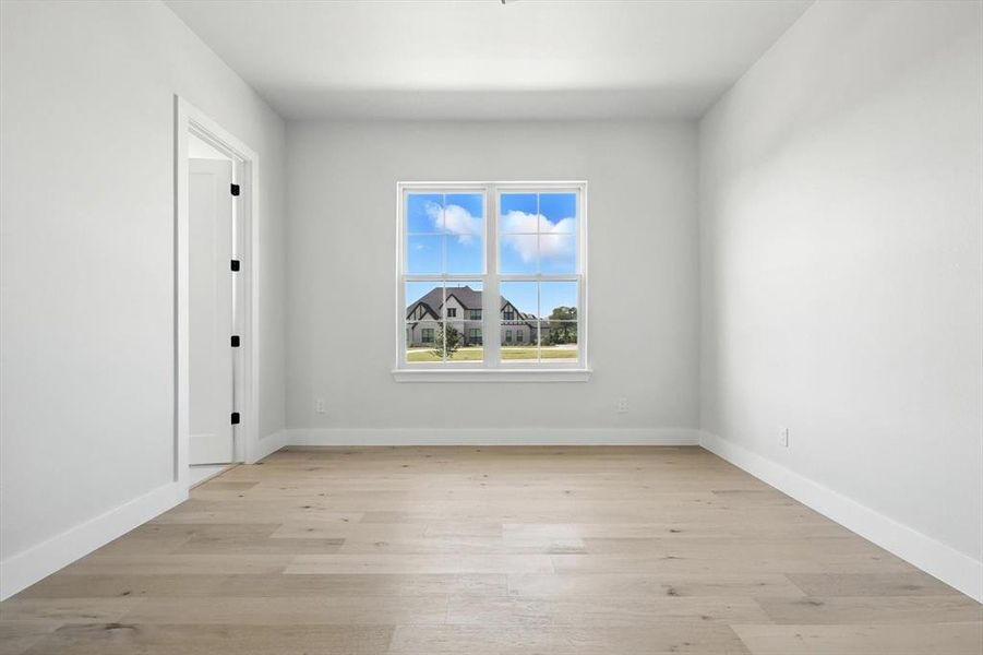 Empty room featuring light wood-type flooring and baseboards Empty room featuring light wood-type flooring and baseboards