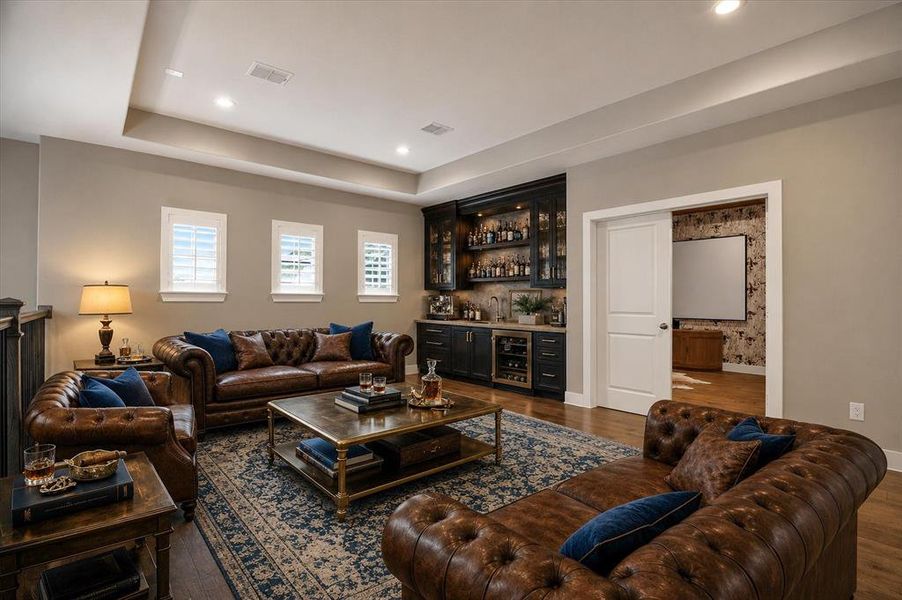 Living area featuring a tray ceiling with recessed lighting Living area featuring a tray ceiling with recessed lighting