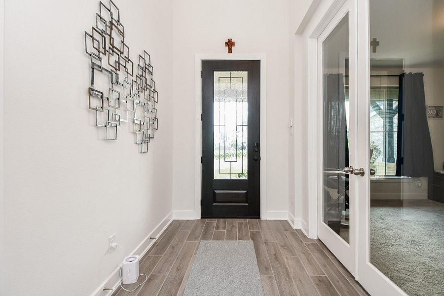Simplicity --- in structure, color themes and beautiful interior features --- add to the kind of easy elegance, imprinted in this inside view of the front entrance. Clear paned french doors (right) open onto a gorgeous 'flex' room, which would be perfect as a private home office/study, or maybe an additional bedroom, if desired. Simplicity --- in structure, color themes and beautiful interior features --- add to the kind of easy elegance, imprinted in this inside view of the front entrance. Clear paned french doors (right) open onto a gorgeous 'flex' room, which would be perfect as a private home office/study, or maybe an additional bedroom, if desired.