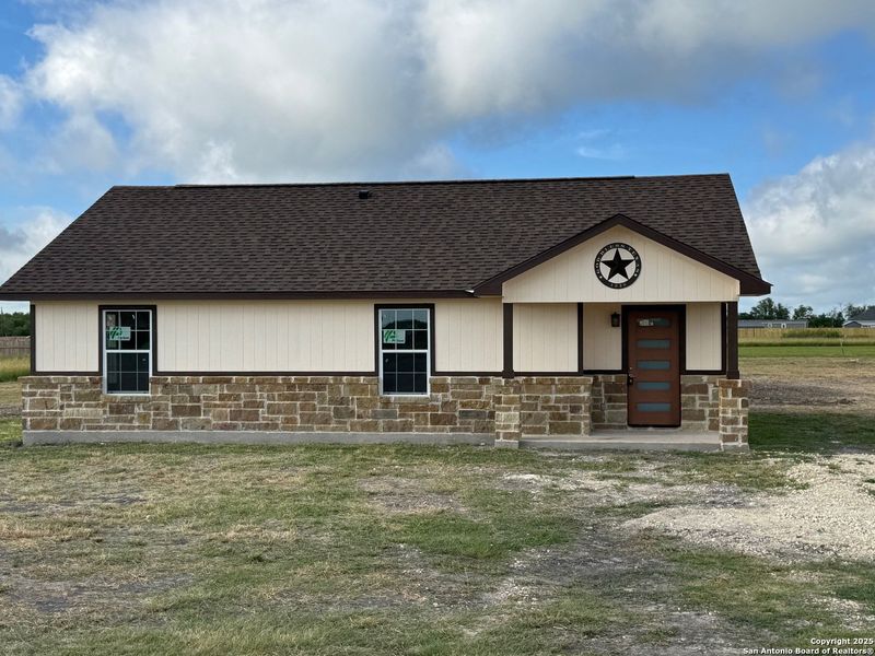Front exterior of a new home in , Natalia, TX, highlighting curb appeal (Image 10).