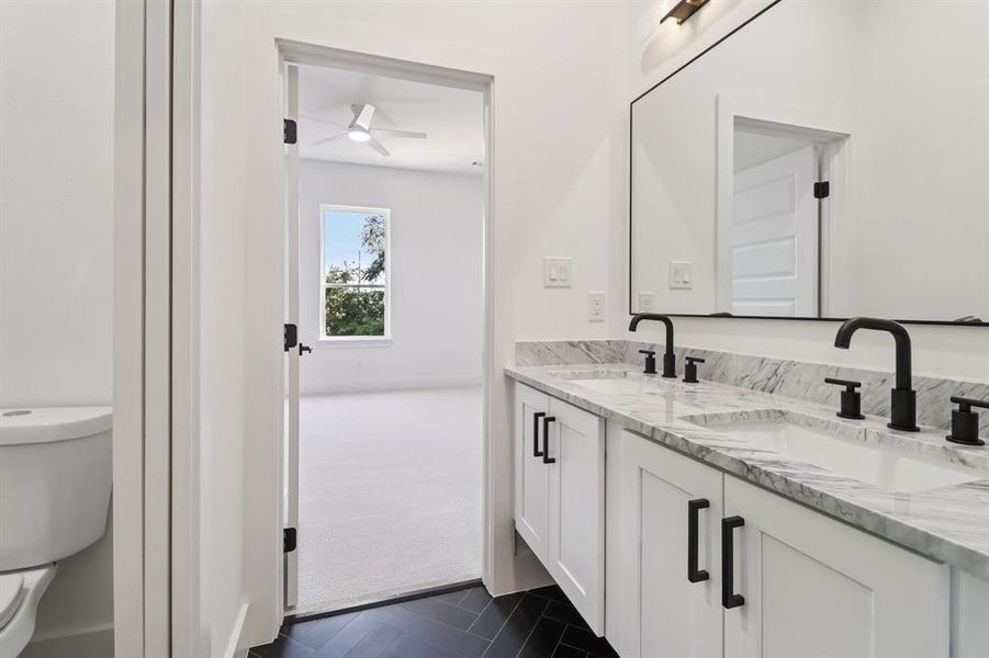 Full bath featuring double vanity and ceiling fan