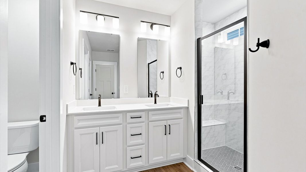 Exceptional en-suite with dual vanity and glass-enclosed tiled walk-in shower for superior everyday comfort Exceptional en-suite with dual vanity and glass-enclosed tiled walk-in shower for superior everyday comfort