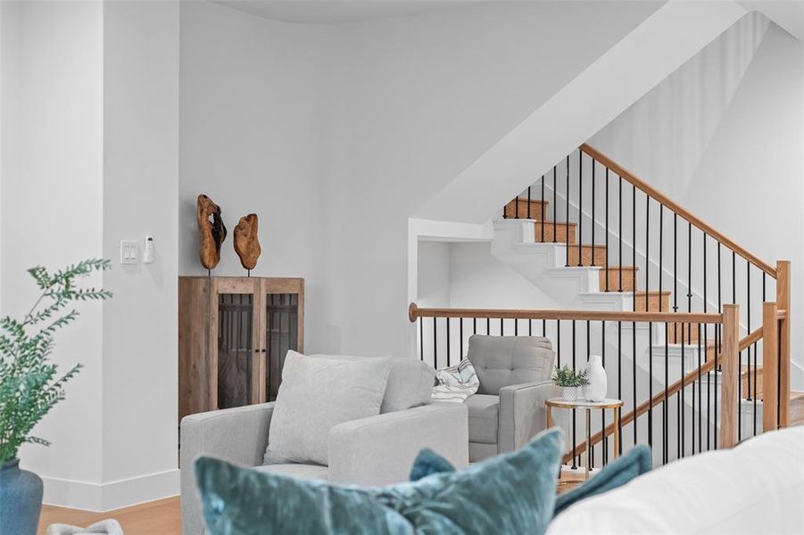 Living area with wood finished floors and baseboards