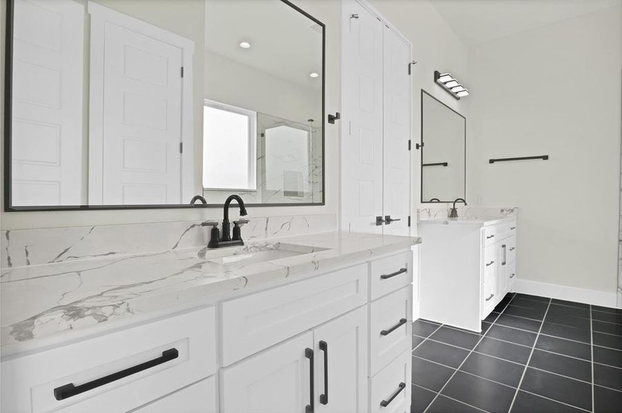 Bathroom featuring tile patterned flooring and vanity