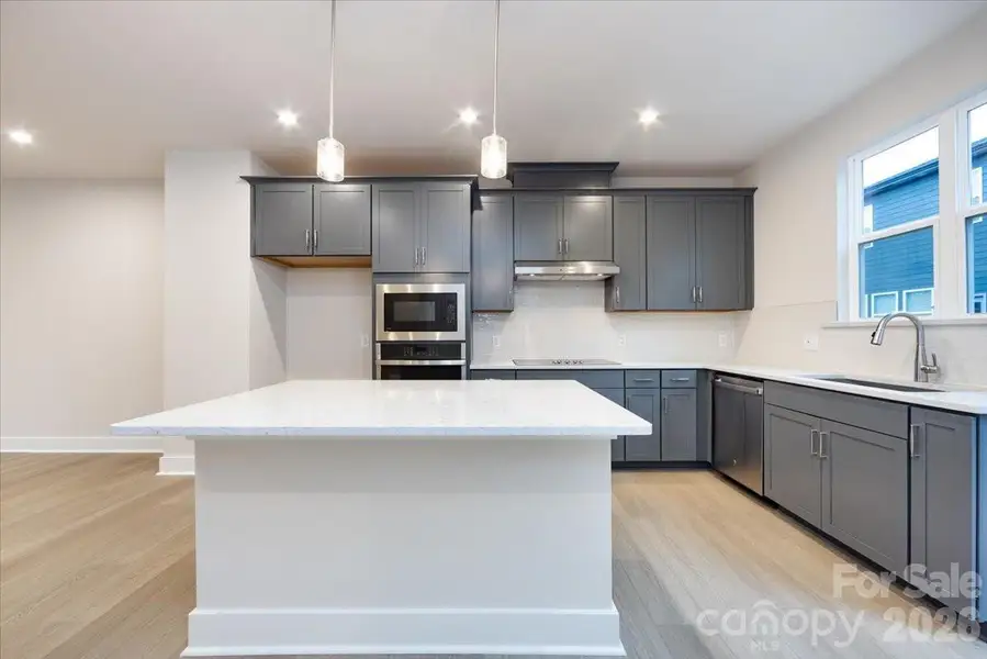Gourmet kitchen with large windows