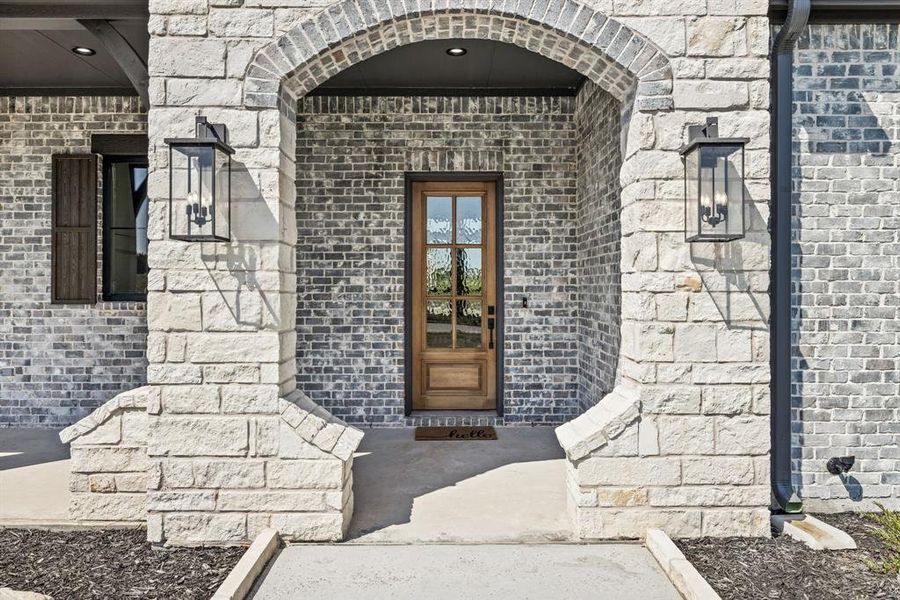 Grand Stone Entry with Custom Hoelscher Door