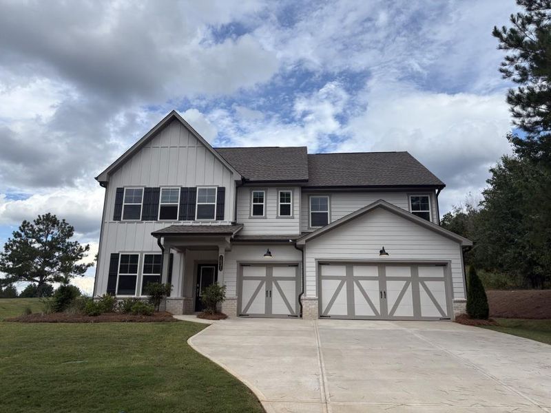 Front exterior of a new home in Wellington Estates, Madison, GA, highlighting curb appeal (Image 1). Front exterior of a new home in Wellington Estates, Madison, GA, highlighting curb appeal (Image 1).