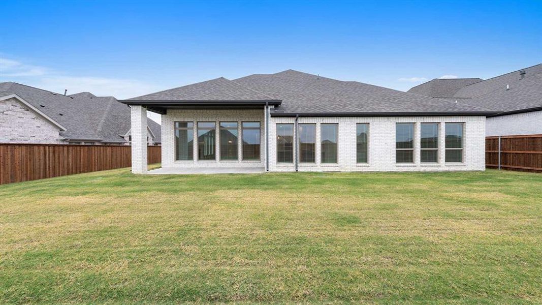 Back of house featuring a patio area and a yard