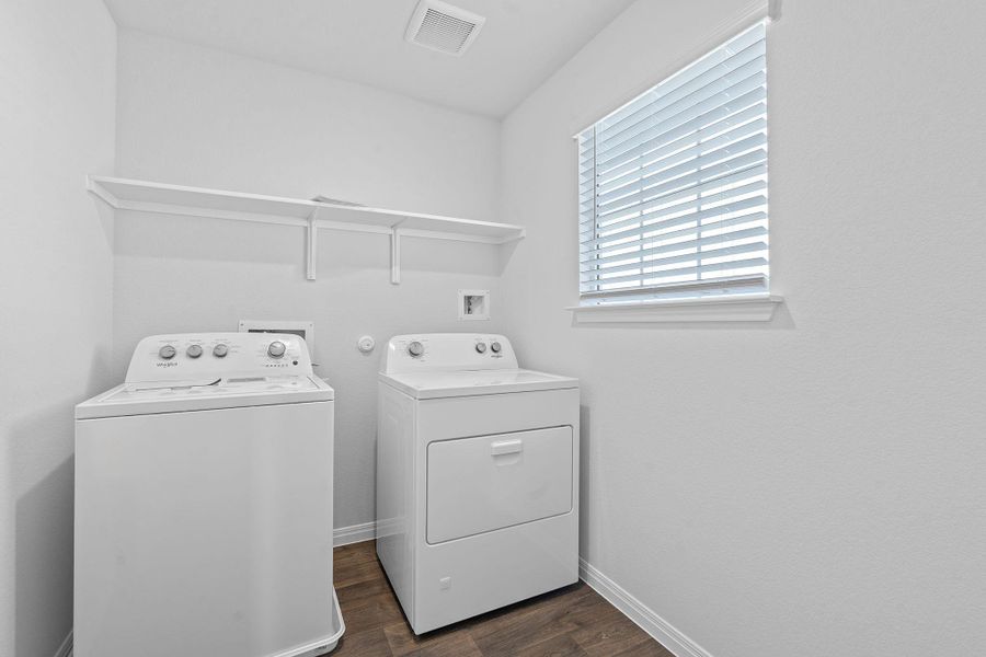 Laundry area featuring dark wood finished floors and washing machine and dryer Laundry area featuring dark wood finished floors and washing machine and dryer