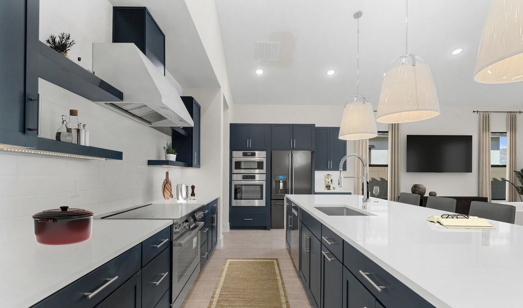 Kitchen with blue cabinets and quartz countertops