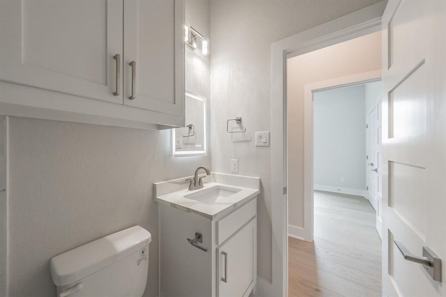 Bathroom featuring vanity and light wood-style flooring