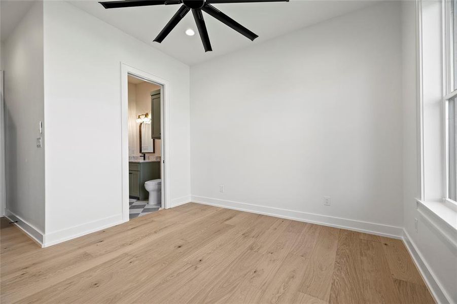 Unfurnished bedroom with light wood-type flooring, recessed lighting, a ceiling fan, and ensuite bath