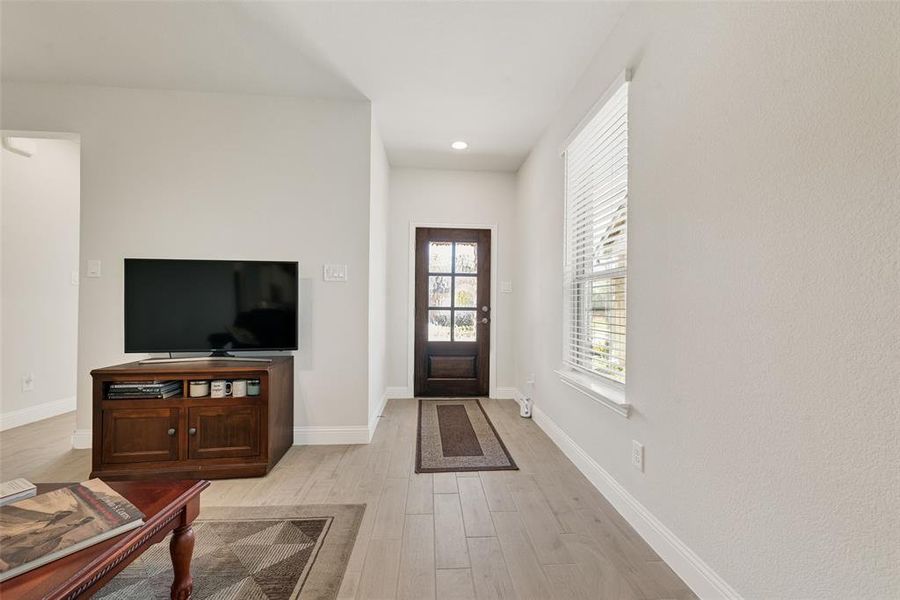 Foyer with light wood finished floors and recessed lighting Foyer with light wood finished floors and recessed lighting