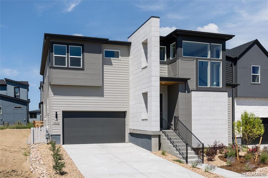 Front exterior of a new home in Lyric at Ridgegate, Lone Tree, CO, highlighting curb appeal (Image 2).