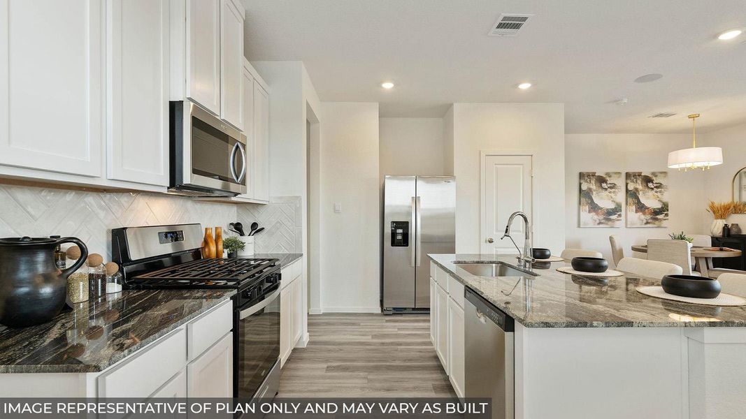 A well-lit kitchen presents a functional island with a sink and ample counter space. A well-lit kitchen presents a functional island with a sink and ample counter space.