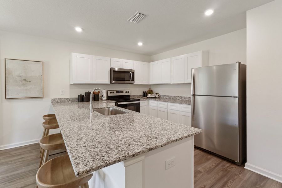 A kitchen with white cabinets. A kitchen with white cabinets.