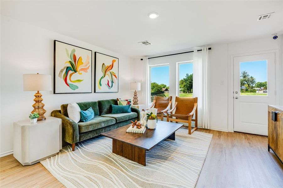 Living room featuring light hardwood / wood-style flooring and a wealth of natural light