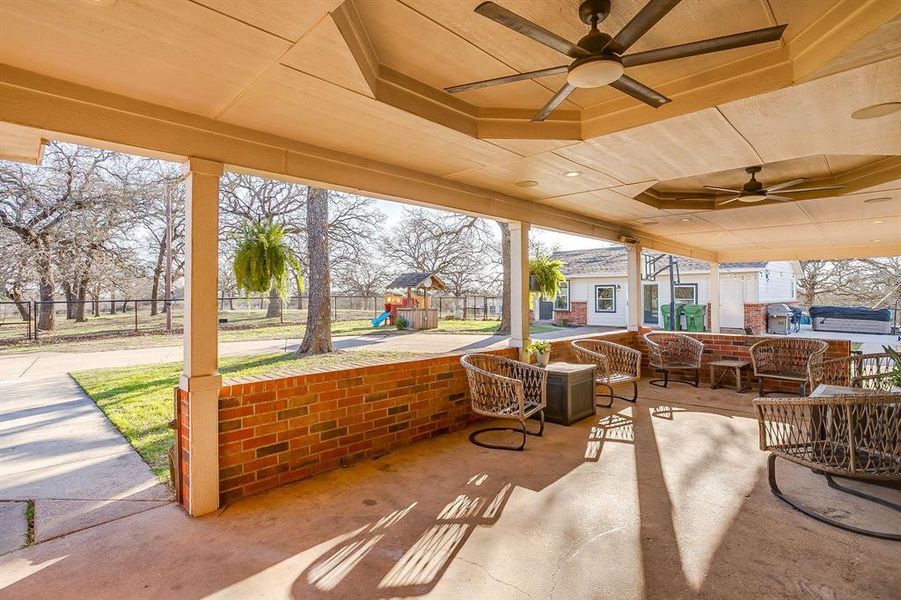 View of patio / terrace featuring a playground, ceiling fan, and an outdoor living space