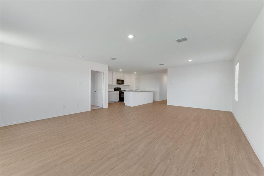 Unfurnished living room featuring light hardwood / wood-style floors