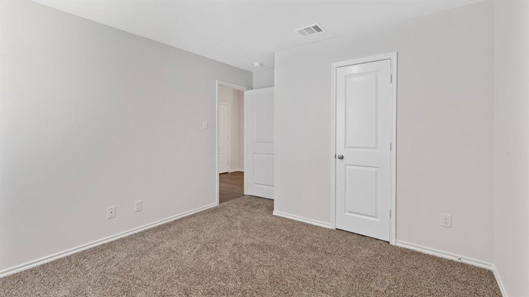 Unfurnished bedroom featuring carpet and baseboards