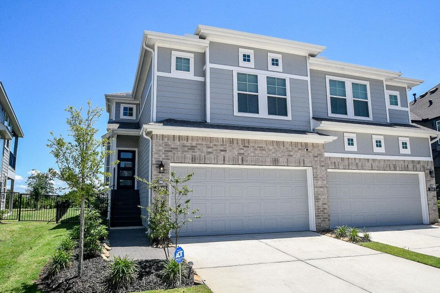 Front exterior of a new home in Bridgeland 45's, Cypress, TX, highlighting curb appeal (Image 1). Front exterior of a new home in Bridgeland 45's, Cypress, TX, highlighting curb appeal (Image 1).
