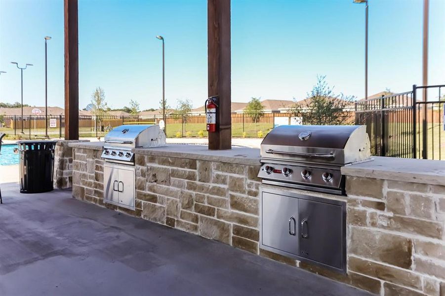 View of patio with an outdoor kitchen and area for grilling