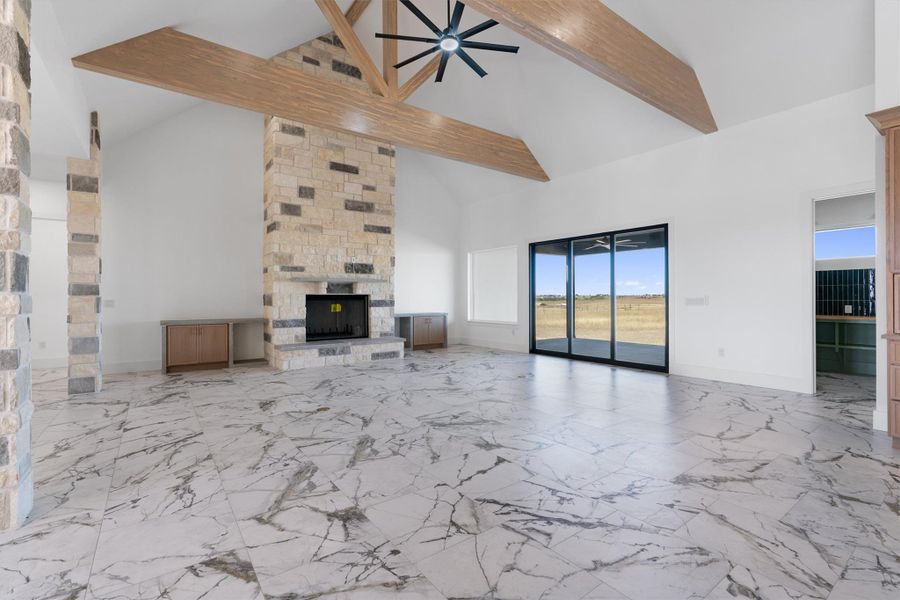 A spacious great room showcases soaring vaulted ceilings and a grand stone fireplace. A spacious great room showcases soaring vaulted ceilings and a grand stone fireplace.