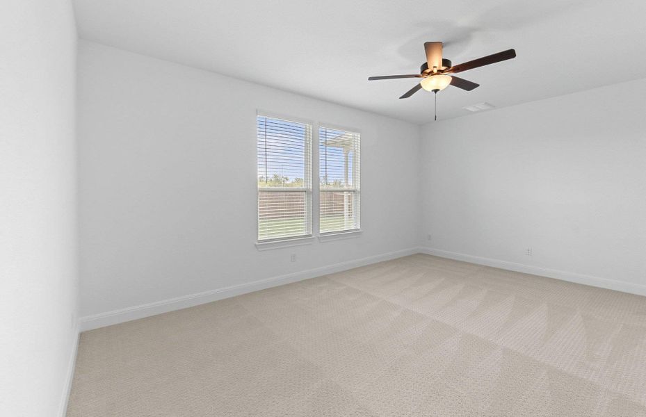 Carpeted spare room with baseboards and a ceiling fan Carpeted spare room with baseboards and a ceiling fan