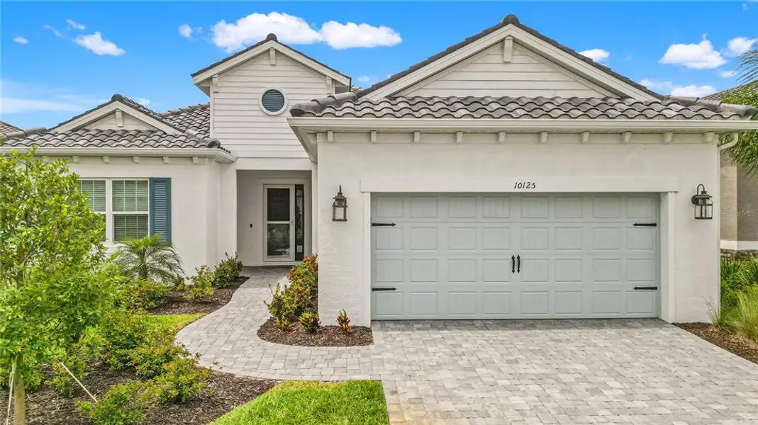 Front exterior of a new home in , Sarasota, FL, highlighting curb appeal (Image 1). Front exterior of a new home in , Sarasota, FL, highlighting curb appeal (Image 1).