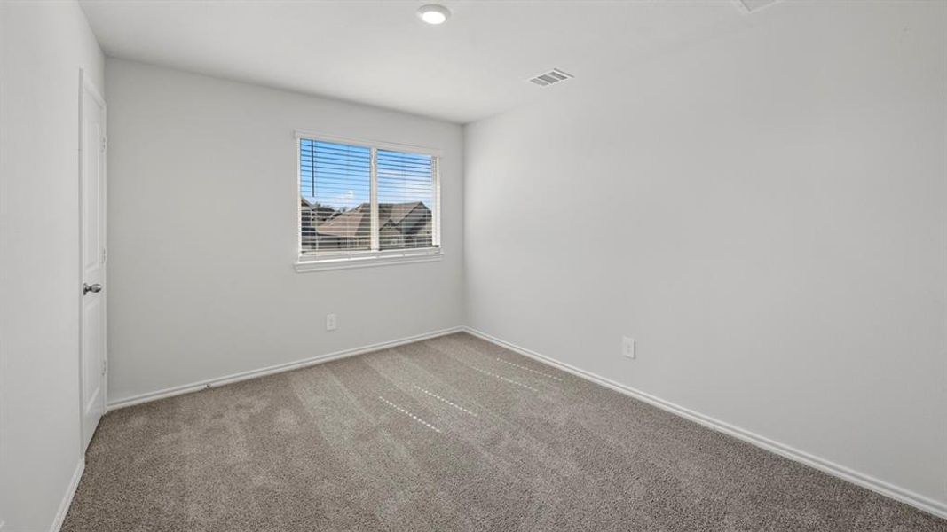 Unfurnished room with light carpet and baseboards