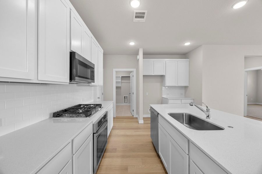 Kitchen in the Magnolia home plan by Trophy Signature Homes – REPRESENTATIVE PHOTO Kitchen in the Magnolia home plan by Trophy Signature Homes – REPRESENTATIVE PHOTO